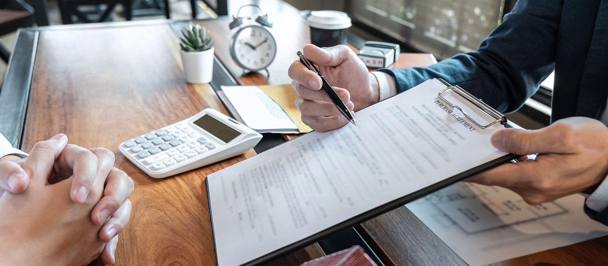 two men filling out loan paperwork