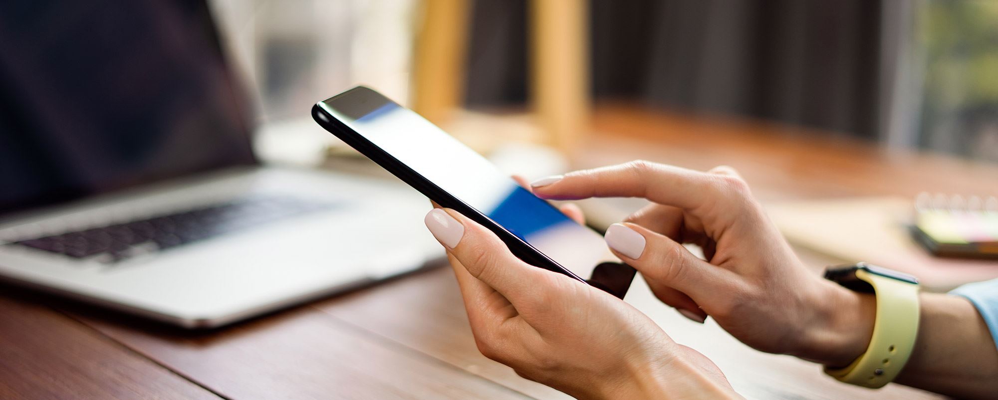 Woman paying bills on a cell phone