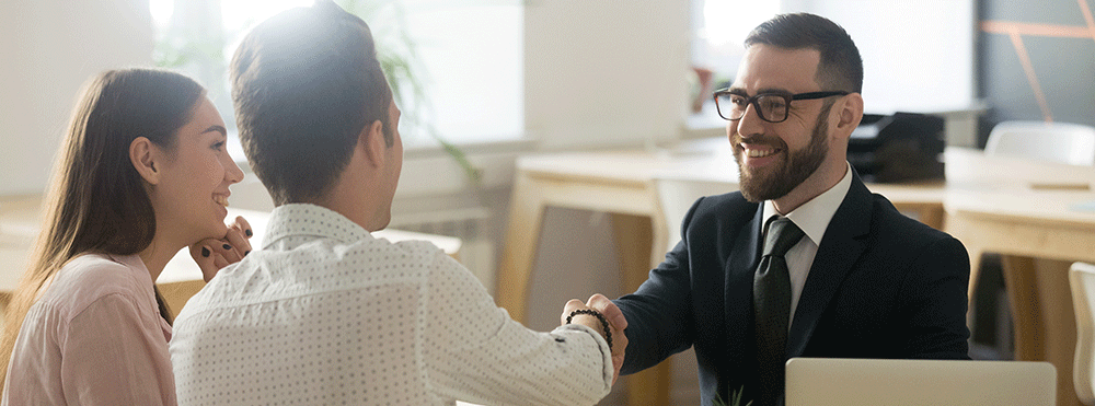 Banker shaking hands with customers